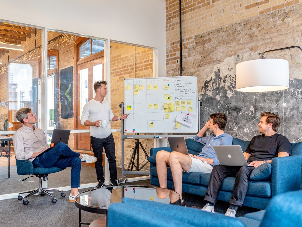 Audit meeting surrounding a whiteboard